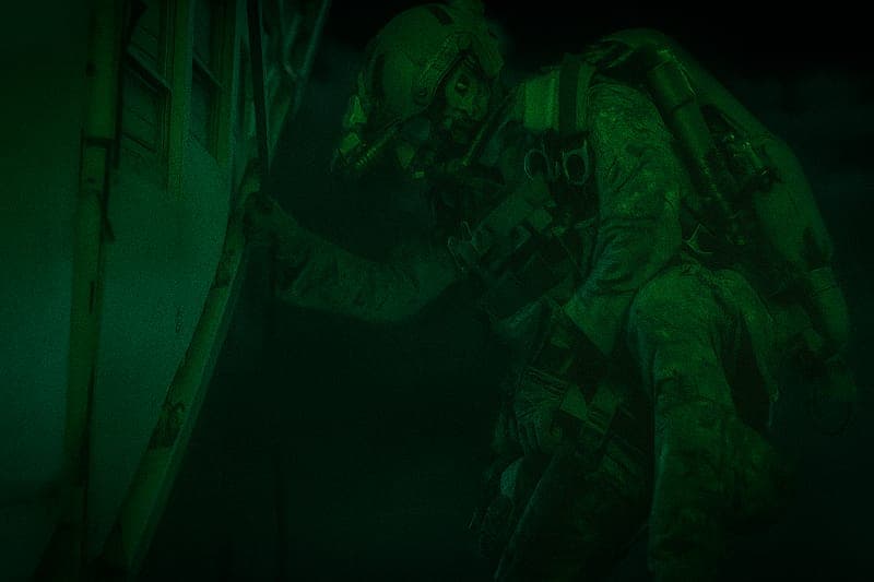 Special Forces soldier ready to jump from aircraft during HALO operation, demonstrating the precise timing and courage required for high-altitude tactical insertion missions